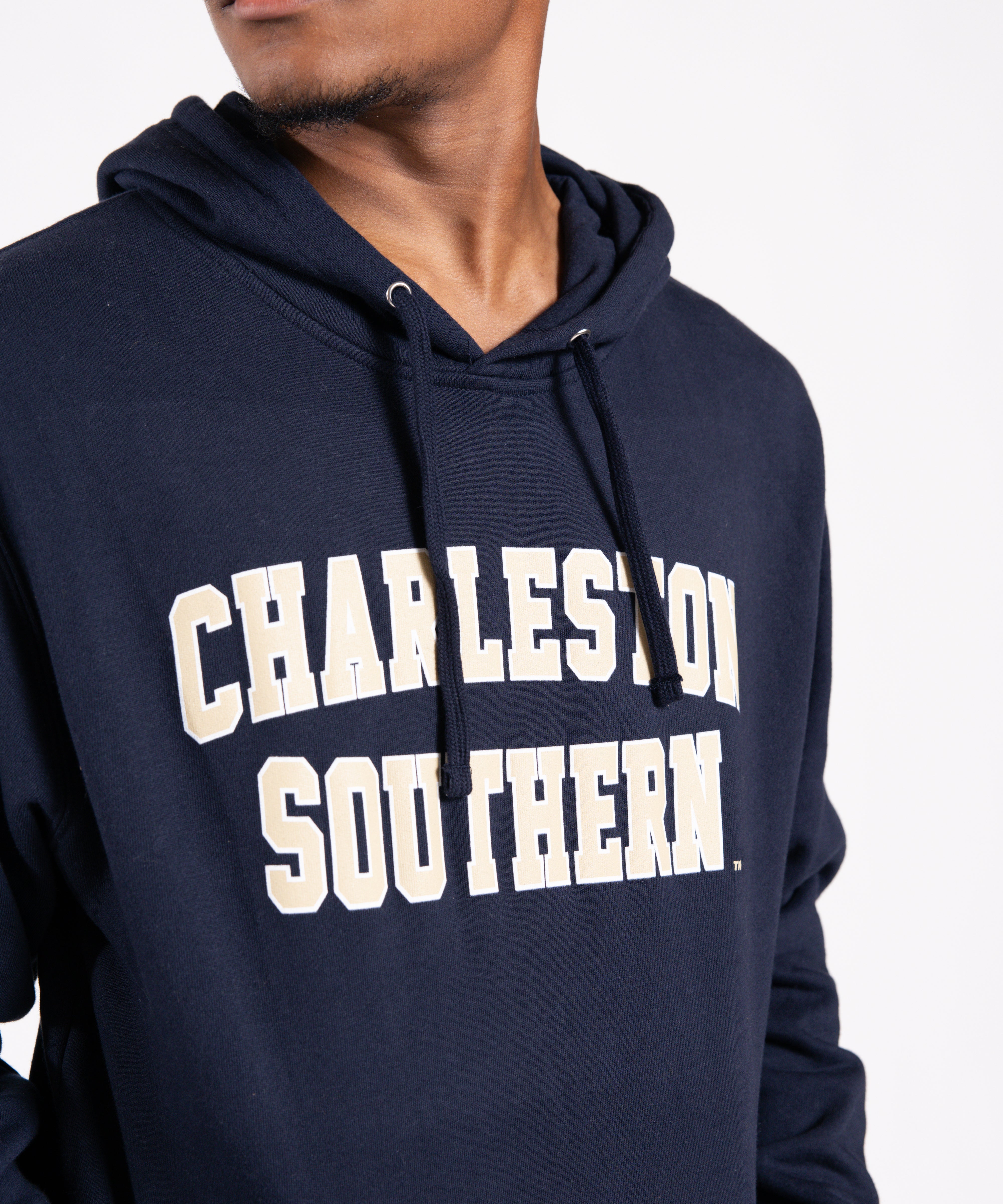 Person wearing a navy hoodie with 'Charleston Southern' text on a white background