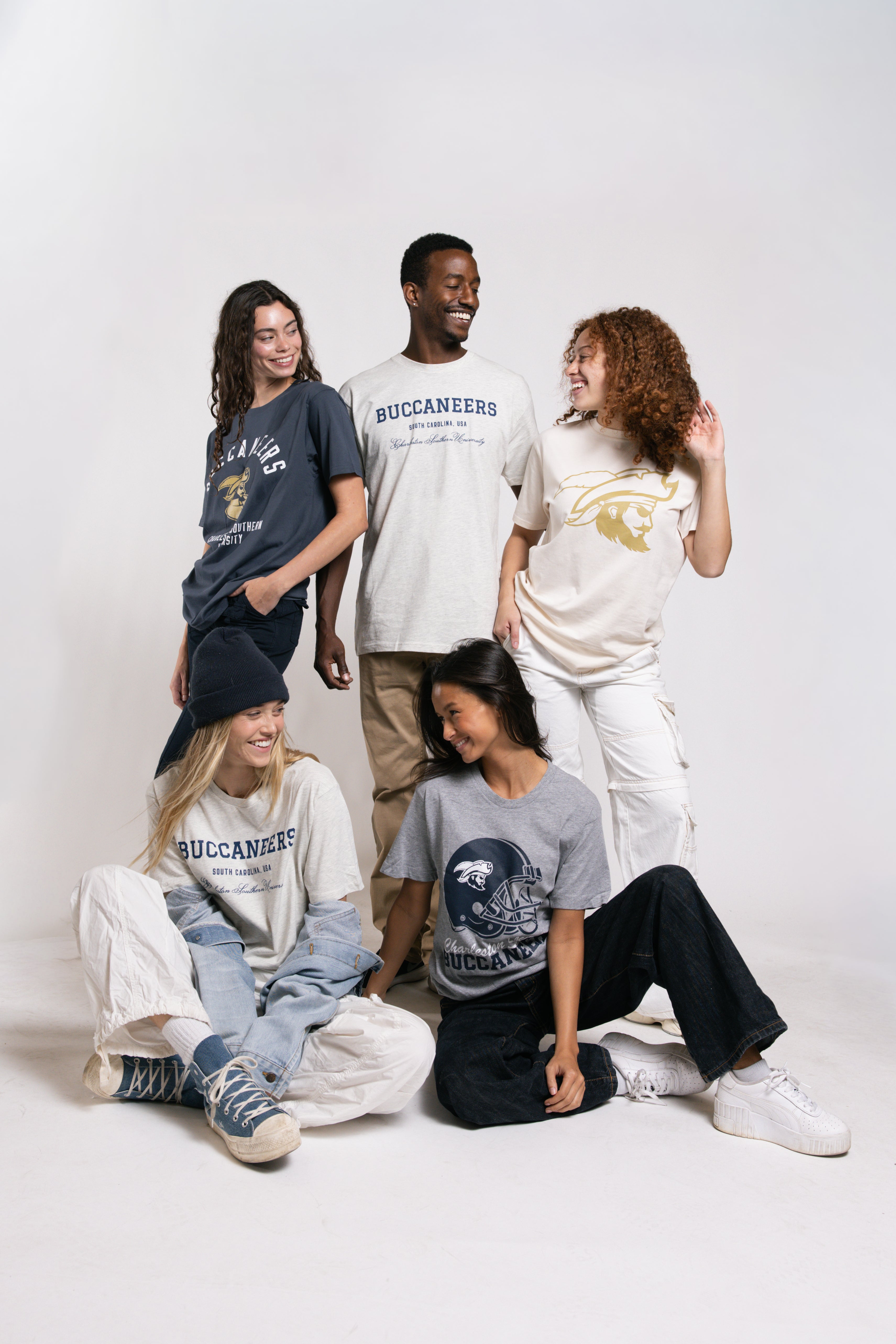 Group of people wearing t-shirts with 'Buccaneers' logo on a white background