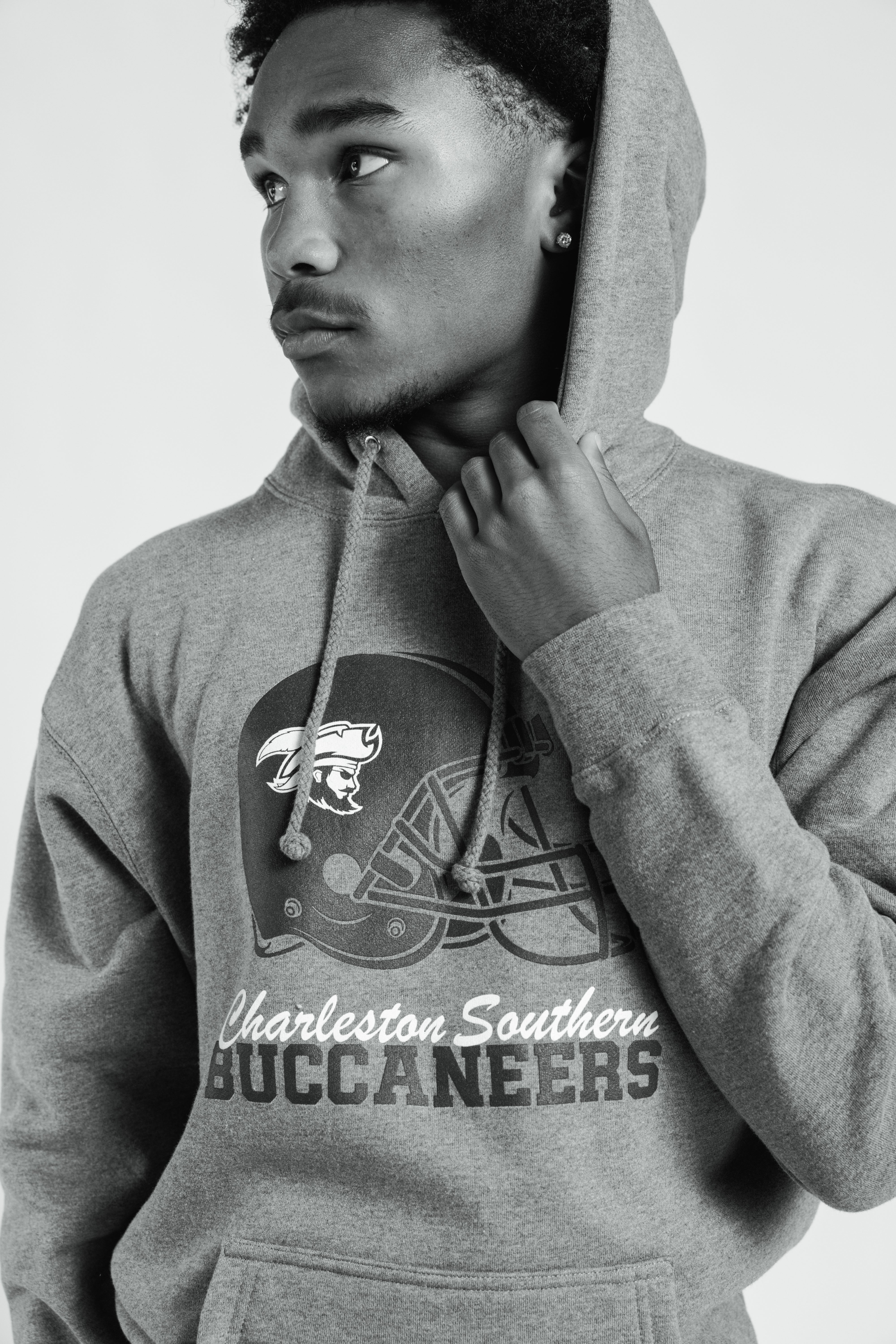 Person wearing a gray hoodie with 'Charleston Southern Buccaneers' logo on a white background
